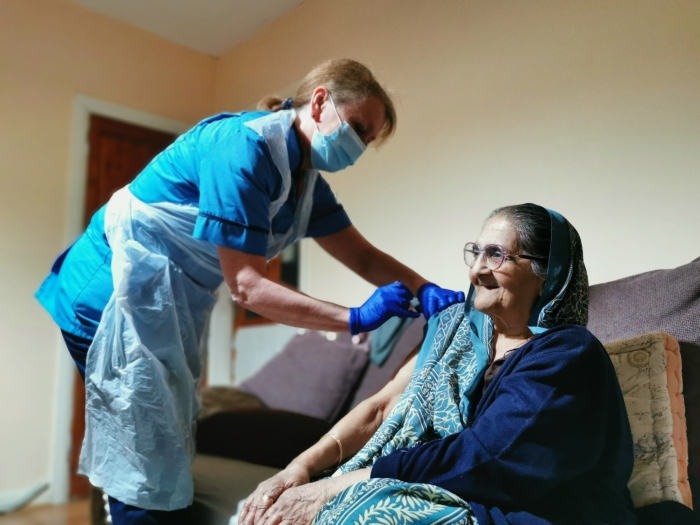 Nurse giving vaccination at home.jpg